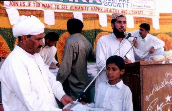 Mr Ahmad Yaar distributing clothes  