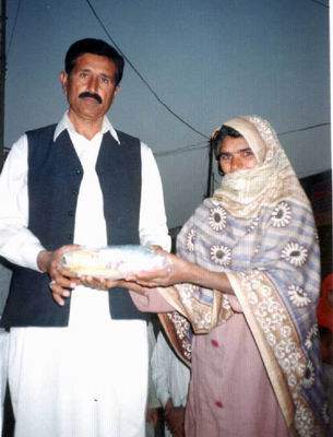 Mr Amin Mitru distributes clothes  