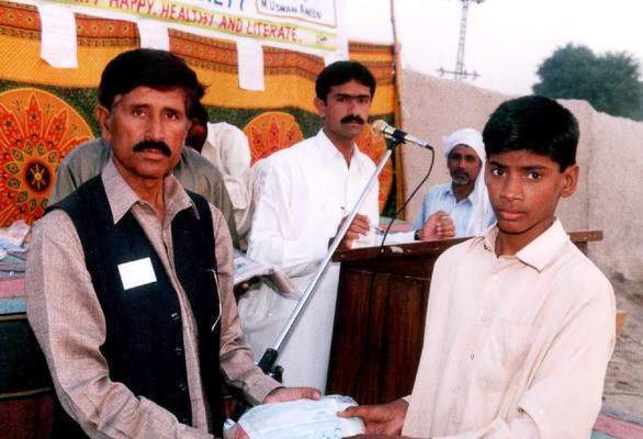 Mr Amin Mitru distrubutes clothes  